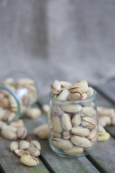 Pistachio nuts in a glass bottle — Stock Photo, Image