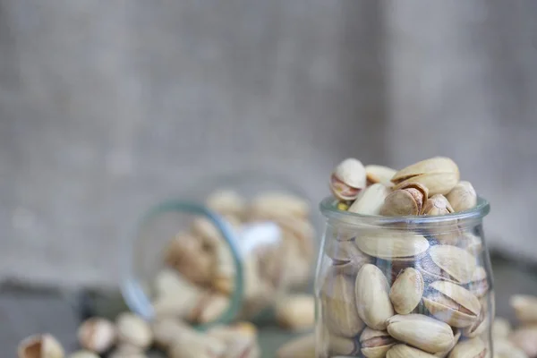 Pistachio nuts in a glass bottle — Stock Photo, Image