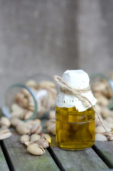 Pistachio nuts in a glass bottle — Stock Photo, Image