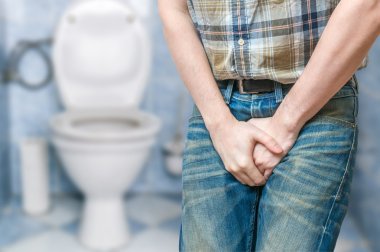 Incontinence concept. Man wants to pee and is holding his bladde clipart