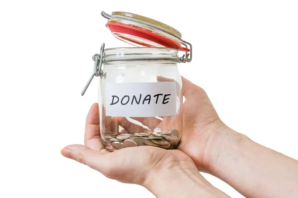 Hands hold jar with coins and donate label. Isolated on white. — Stock Photo, Image