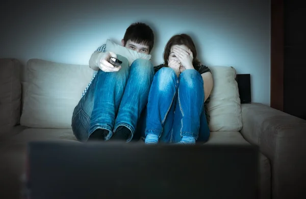 Young scared couple is watching horror on TV. — Stock Photo, Image