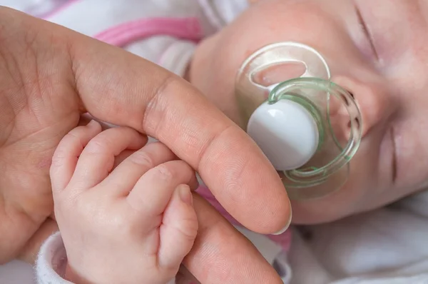 Adoption baby concept. Man is touching baby with hand. — Stock Photo, Image