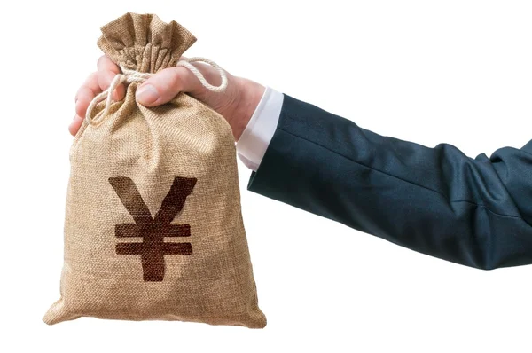 Hand of businessman holds bag full of money with Yen sign. Isolated on white background. — Stock Photo, Image