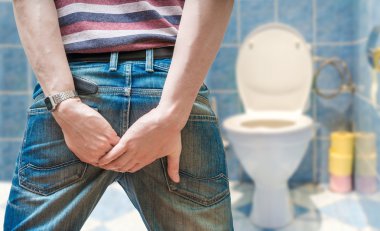 Man suffers from diarrhea in restroom.  clipart