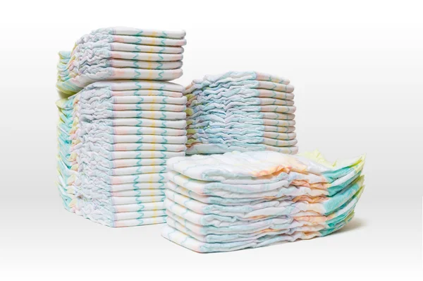 A lot of stacked diapers isolated on white background. — Stock Photo, Image