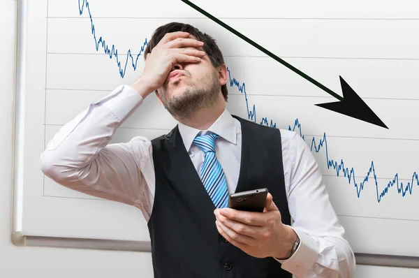 Bad investment or economic crisis concept. Businessman is disappointed from losing in stock exchange. Chart with arrow down on whiteboard in background. — Stock Photo, Image