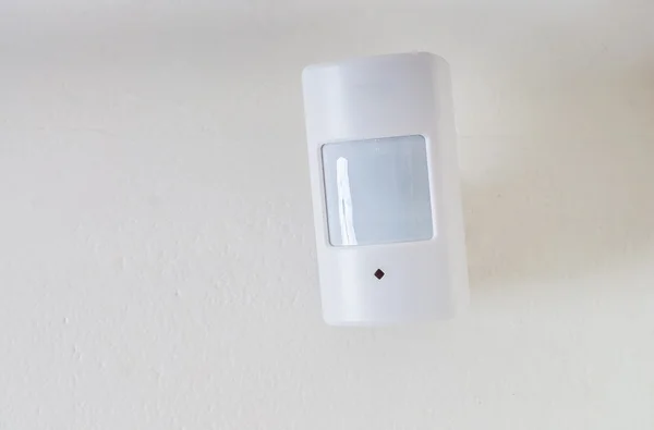 Motion sensor or detector for security system mounted on wall.