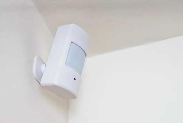 Motion sensor or detector for security system mounted on wall. — Stock Photo, Image