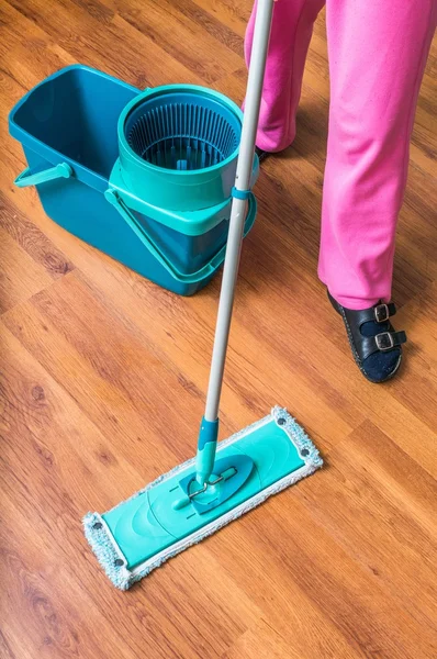 Woman is cleaning wooden floor with mop. — Stock Photo, Image