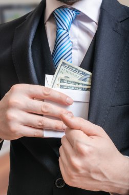 Yolsuzluk kavramı. İşadamı mektup dolu para ya da takım elbise ceket rüşvetle gizleme.