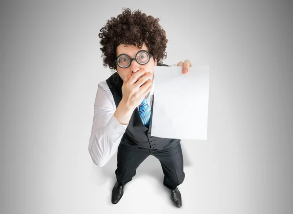 Top view on disappointed businessman showing white empty paper for custom message. — Stock Photo, Image