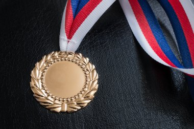 Golden medal - award for a winner on black background. clipart