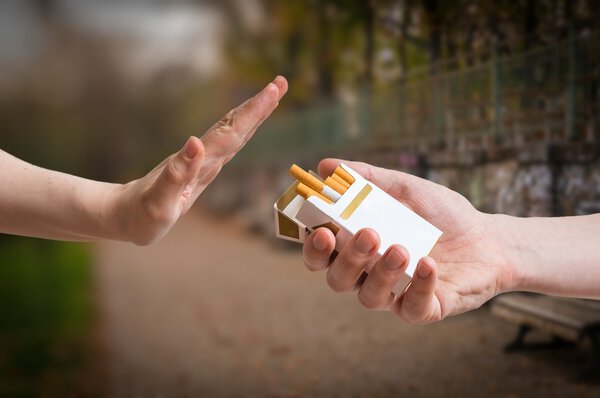Quitting smoking concept. Hand is rejecting cigarette offer.