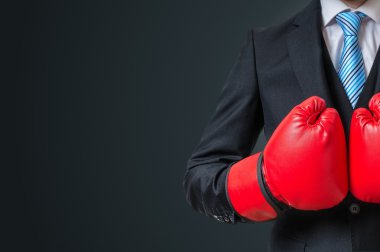 Boxing businessman with red gloves and empty space in background clipart
