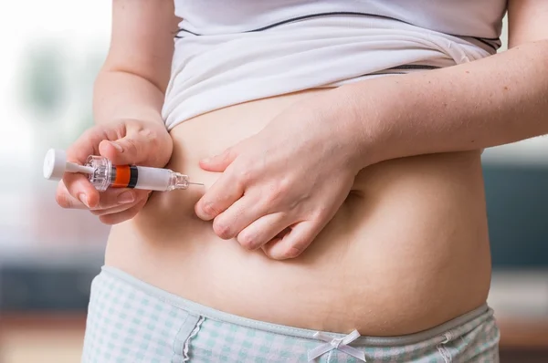 Ivf und Behandlungskonzept für Unfruchtbarkeit. Patientin spritzt Hormone mit Spritze in Bauch. — Stockfoto