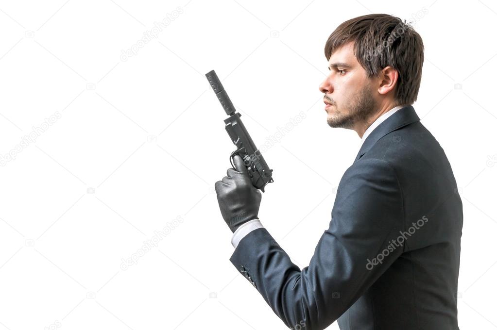 Secret aghent or spy holds pistol with silincer in hand. Isolated on white background.