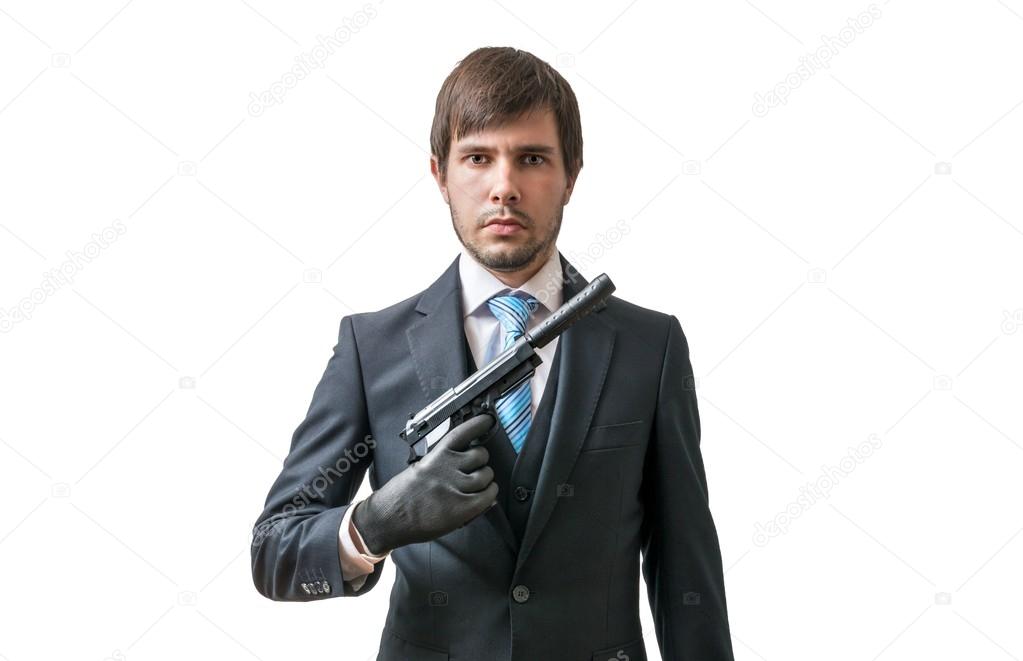 Secret agent or murderer with pistol in hand. Isolated on white background.