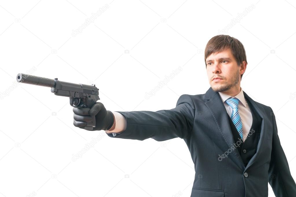 Secret agent is aiming with pistol with silencer. Isolated on white background.