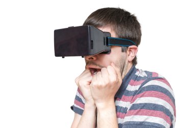 Genç adam 3d sanal gerçeklik gözlük takıyor ve korkmuş durumda. Beyaz arka plan üzerinde izole.