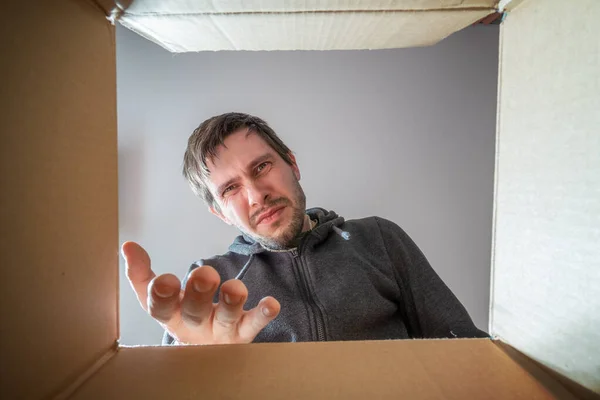 Young Disappointed Displeased Man Opening Gift Looking Cardboard Box — Stok fotoğraf