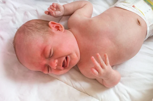 Baby or newborn is crying and suffers from colic — Stock Photo, Image