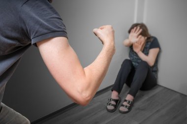 Domestic violence concept. Jealous husband is abusing his wife a fist. clipart