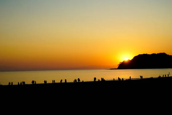Dusk and the people of the silhouette of Kamakura coast