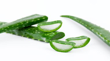 Aloe vera taze ıslak yapraklar ve beyaz arka planda dilimler
