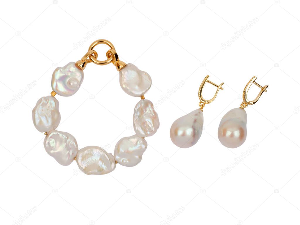 Luxury elegant baroque pearl earrings and bracelet isolated on white background. Close-up shot