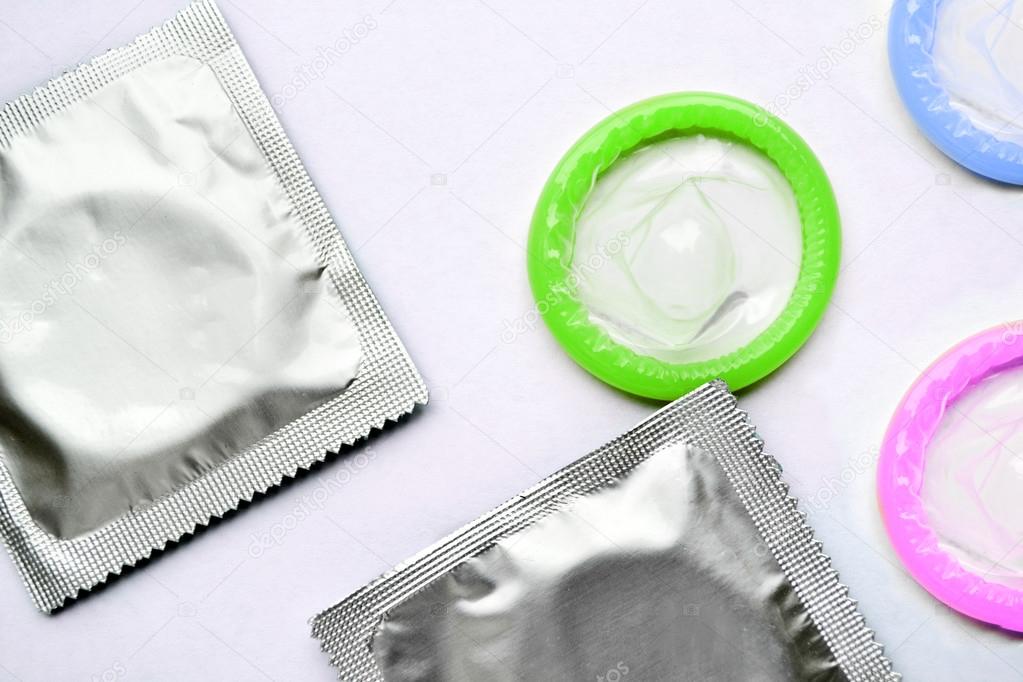 Couple of colorful condoms isolated on white