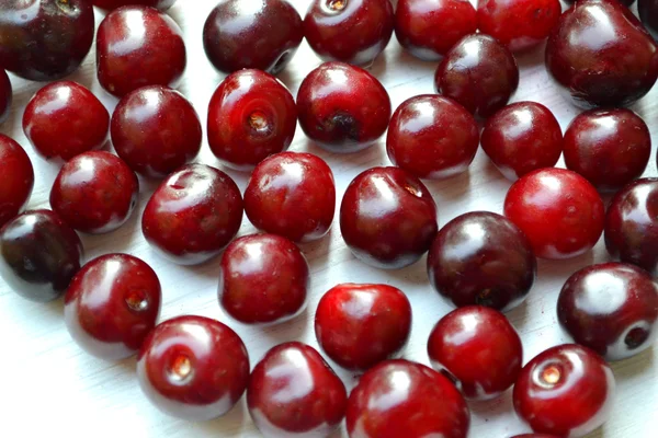 Lots of fresh and tasty dark sweet cherries isolated on white — Stock Photo, Image