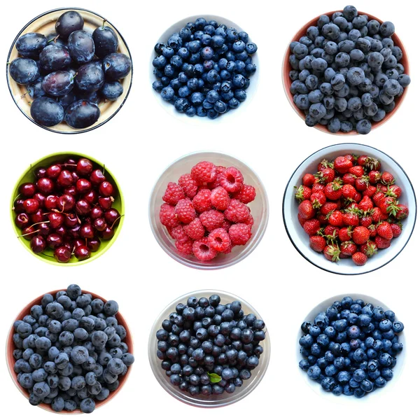 A lot of bright strawberries, raspberries, cherries and blueberries isolated on white — Stock Photo, Image