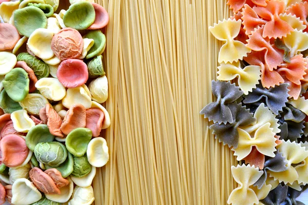Conjunto de diferentes tipos de massas italianas coloridas na mesa de madeira — Fotografia de Stock