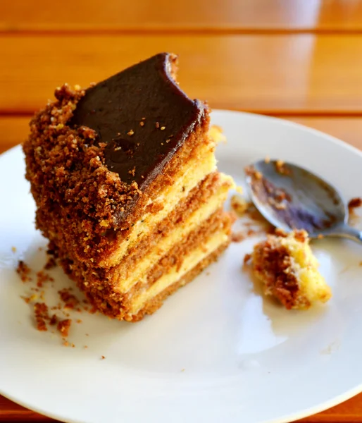 Slice of already bitten chocolate cake — Stock Photo, Image