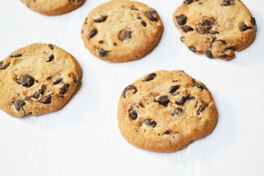 Beyaz ahşap masa üzerinde lezzetli çikolata kurabiye