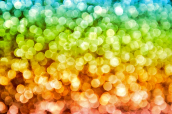 Brilhante e abstrato desfocado colorido arco-íris fundo com brilho cintilante — Fotografia de Stock