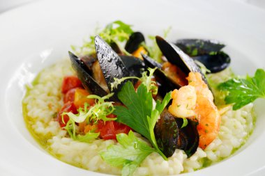 Deniz ürünleri midye ve karides beyaz tabakta bir restoranda lezzetli risotto