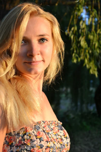 Young beautiful blond woman with long hair looking directly and smiling gently — Stock Photo, Image