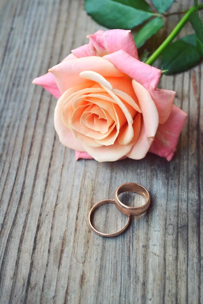 Dois anéis de ouro noivado com um lindo casamento rosa rosa — Fotografia de Stock