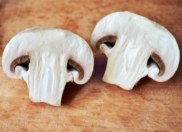 Raw white mushrooms cut in two pieces