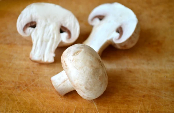 Raw white mushrooms cut in two pieces