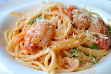 Delicious pasta spaghetti with shrimps and other seafood clipart