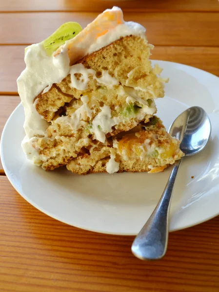 Slice of fruit cake with cream, kiwi and orange — Stock Photo, Image