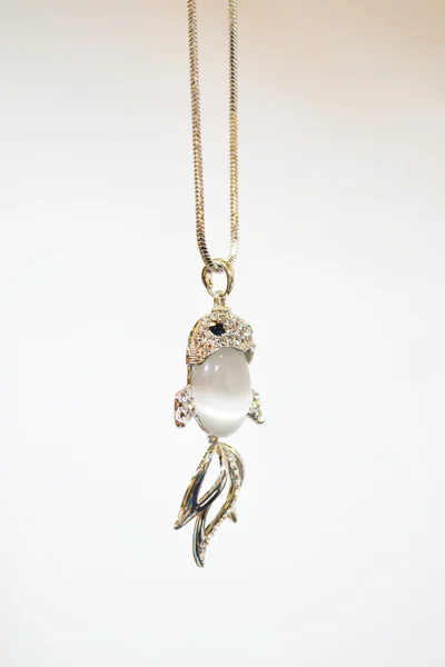 Beautiful silver necklace in shape of a fish with precious gems - diamonds and cat's eye — Stock Photo, Image