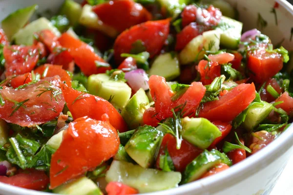 Tasty vegetarian salad with tomatoes and cucumber Royalty Free Stock Images