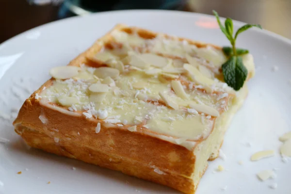 Belgian waffle with cream, coconut and mint — Stock Photo, Image