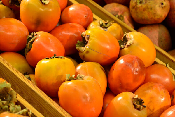 Persimmon and pomegranate in grocery store