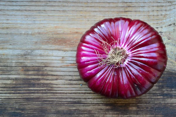 Big red onion on wooden table — Stock Photo, Image