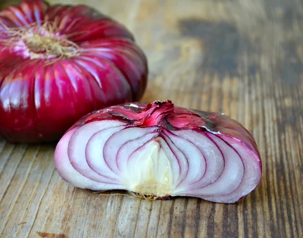 Big red onion on wooden table — Stock Photo, Image